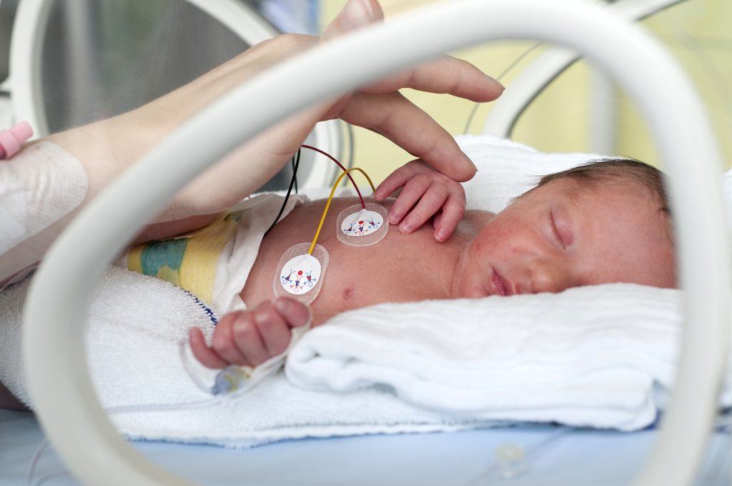 Newborn baby in incubator